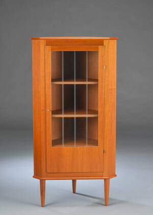  Hjørneskab af massiv og fineret teak, front med glasdør.