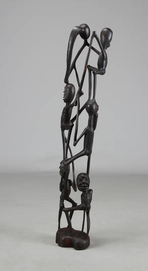 Afrikansk figur af sort træ, udskåret med figurer. Tanzania.