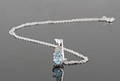 Blue topaz and diamond pendant necklace