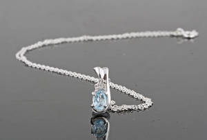 Blue topaz and diamond pendant necklace