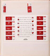 Danmark. Indstiksbog stoppet med brugte frankeringsetiketter i mange forskellige værdier. Også 2 postfriske TIllykke-ark