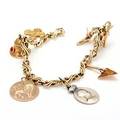 Armbånd af 14 kt. guld prydet med charms af 18 og 14 kt. guld og sølv delvist prydet med farvede sten. L. ca. 20 cm. Vægt ca. 37,5 gr.