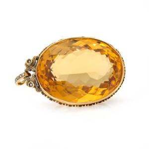 Citrinvedhæng af forgyldt sølv prydet med facetsleben citrin. L. ca. 5 cm. Ca. 1900-1910.