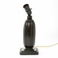 Just Andersen Bordlampe af patineret diskometal, kanelleret korpus og firesidet fodstykke. H. ekskl. fatning 26,5.