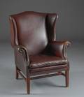 Wingback chair i patineret brunt læder