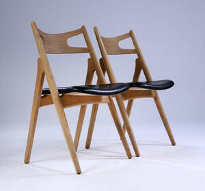 Hans J. Wegner. To savbukkestole af eg, sort læder 2  Denne vare er sat til omsalg under nyt varenummer 5007248