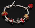Bacio, Italien. Armbånd med 7 charms, nogle med julemotiver, sterlingsølv