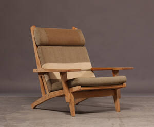 Hans J. Wegner. Højrygget lænestol med stel af massiv egetræ