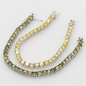 ARMBAND, silver, två st, besatta med gröna och gula citriner.