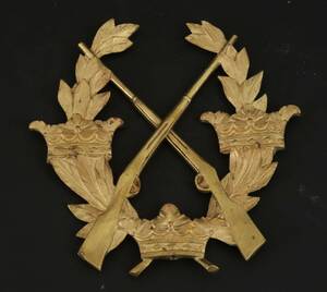 Dekoremblem i bronserad metall och mässing, 1900-tal