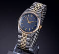 Rolex Oyster Perpetual. Vintage herreur i 18 kt. guld og stål med mørkeblå skive, ca. 1960erne