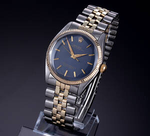 Rolex Oyster Perpetual. Vintage herreur i 18 kt. guld og stål med mørkeblå skive, ca. 1960erne