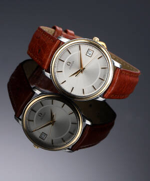 Omega De Ville. Herreur i guld og stål med sølvfarvet skive, ca. 1998