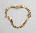 Armband i 18 k guld manglad pansar