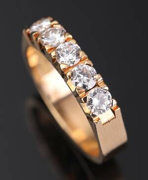 Alliancering af 18 kt. guld prydet med 5 brillantslebne diamanter, i alt ca. 0.80 ct