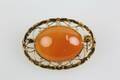BROSCH, med cabochonslipad rödorange sten, guld, 14 k, ca 4,7 g